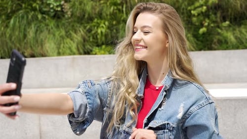 Smiling Woman Posing for Selfie Outdoors in Daylight