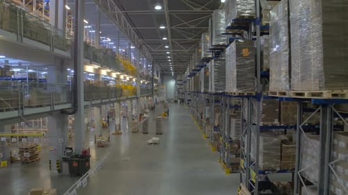 Huge Warehouse and Forklifts, Racks with Goods.