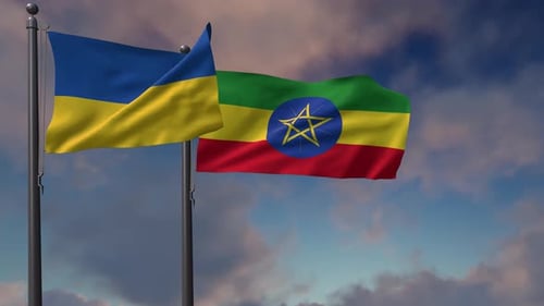 Ukrainian and Ethiopian National Flags Waving against a Cloudy Sky