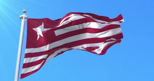Realistic Liberia Flag Waving in Bright Blue Sky
