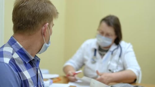 Patient Consults with Doctor in Medical Office