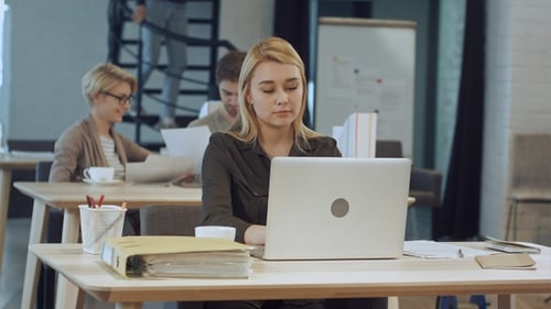 Young woman working on laptop in the office