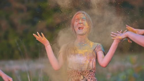 Joyful Woman Celebrates Holi with Colorful Powder