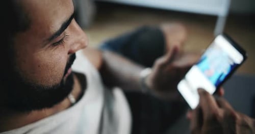 Young Adult Using Smartphone at Home
