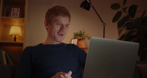 Crop View of Handsome Red Haired Man Talking and Typing While Using Laptop for Communication at Home