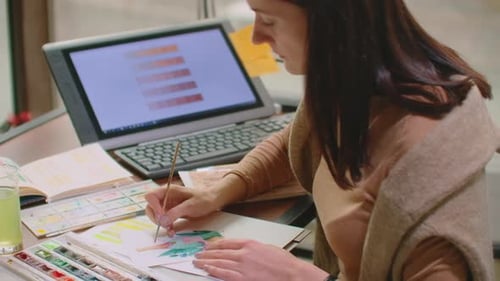 Young Graphic Designer Working on Modern Desktop Computer While Using Graphic Tablet at Desk in the