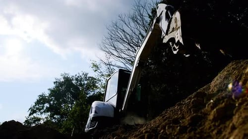 Excavator Digging Soil in a Rural Setting