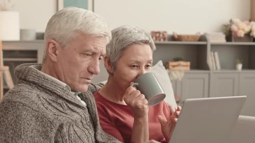 Mature Couple Using Laptop Together at Home