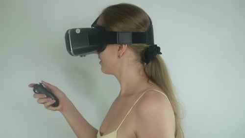 Woman Experiencing Virtual Reality with Headset and Remote