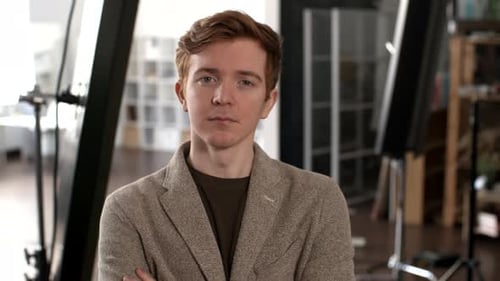 Red Haired Young Man Looking at Camera