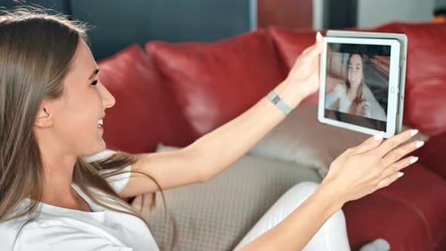 Smiling Woman Video Calling on Tablet Device