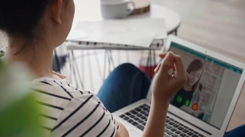 Woman Video Calling On Laptop Showing Chart
