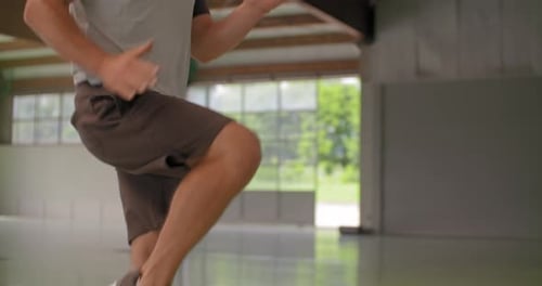 Man Exercising by Jogging in Place Indoors