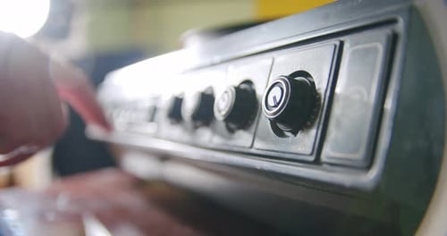 Hand Adjusts Dials on Electronic Equipment