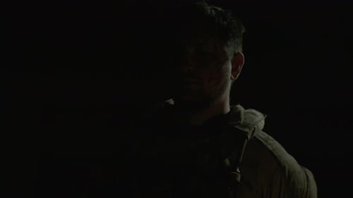 Man in Camouflage with Face Paint Looking at Camera