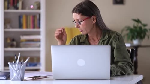 Woman Working on Laptop at Home