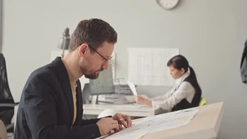 Couple of Engineers Working in Design Office