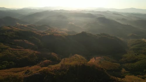 4K Aerial view from drone over mountains fog. Golden scenery at sunrise