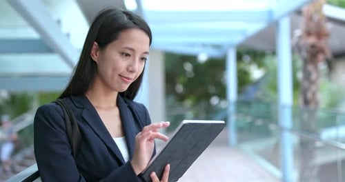 Woman Using Tablet in Urban Setting