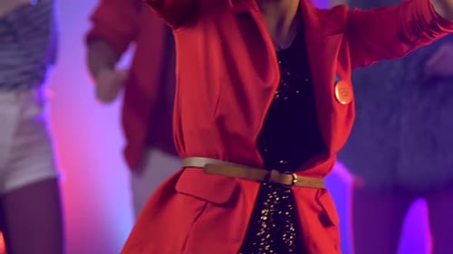 Enthusiastic Woman Dancing with Friends at Lively Party