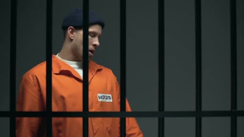 Young Adult Walks in Jail Cell