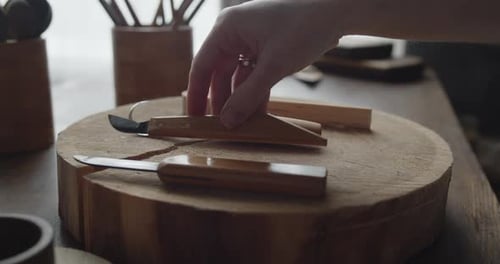 Close-up of Woman Carpenter's Hand Choosing Tools for Carving Wood