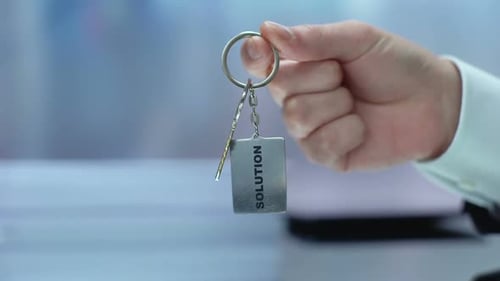 Solution Word on Keychain Hand Showing to Camera, Accepting Opportunity, Startup