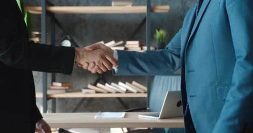 Closeup Hands of Top Managers Shaking Hands with Each Other at Modern Office