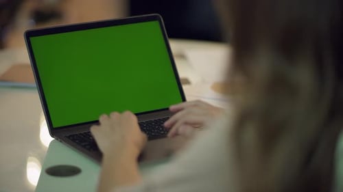 Business Woman Working on Laptop Computer with Green Screen