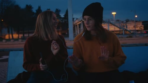 Friends Listening to Music Together at Night
