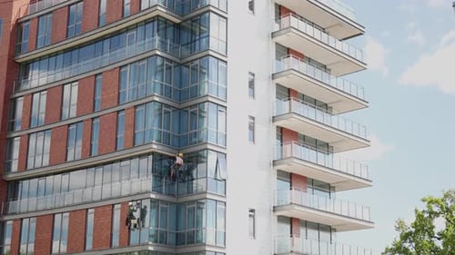 Window Facade Glass Cleaners Climbers Washers on Industrial High Office Building