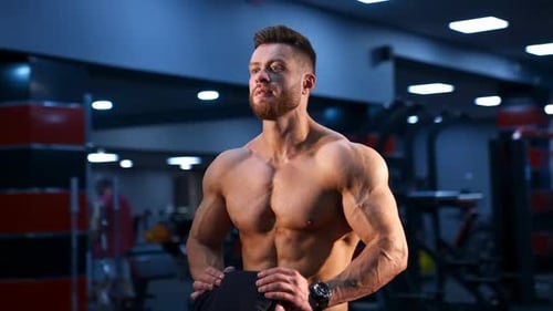 Circle view on handsome male bodybuilder with strong body and perfect abs. Male with naked torso.