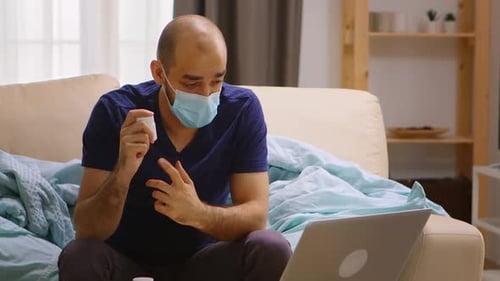 Man Talking About Medication on Laptop at Home