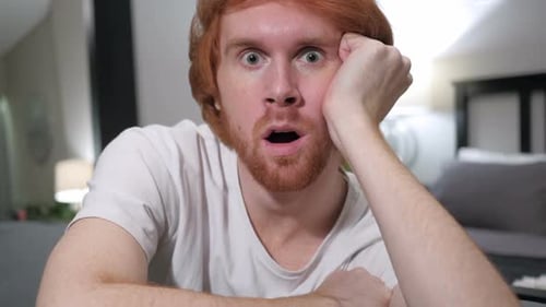 Wondering Shocked Casually Sitting Redhead Man Close Up