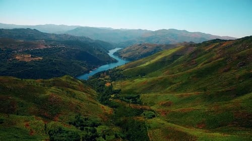 Stunning Landscape Of Mountain Pass With Lush Green Meadow and Stream At Daytime