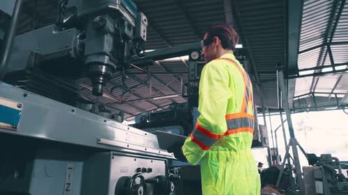 Smart Factory Worker Using Machine in Factory Workshop