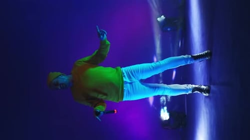 Young Adult Performing on Stage with Microphone