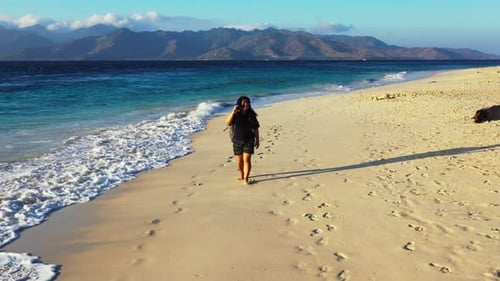 Lady sunbathing on tranquil shore beach break by transparent sea with white sand background of the M