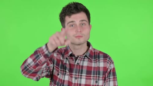 Portrait of Young Man Pointing at the Camera Green Chroma Screen