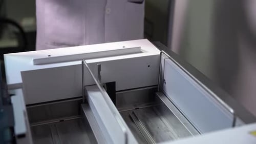 Lab Technician Places Test Tubes in Machine