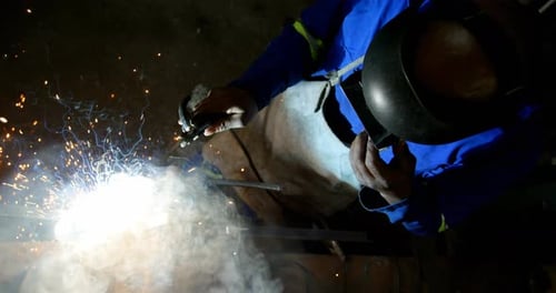 Metalsmith using welding torch in workshop 4k