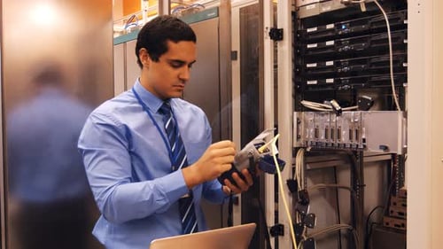 Young Adult IT Technician Testing Servers