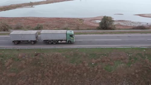 An Aerial View of a Truck with Trailer Driving Along the Highway