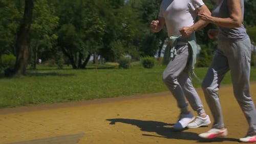 Senior Man and Woman Jogging in Park, Health Care, Active People Slow-Motion