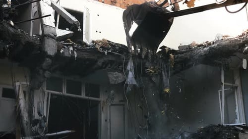 Excavator Demolishes Building in an Urban Area