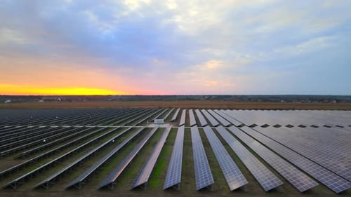 Solar cell power plants at solar farm at summer sunset, large solar panels, HDR video