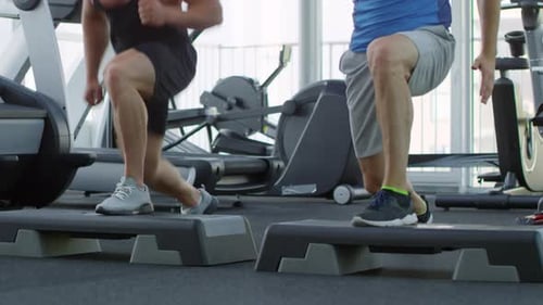 Men Doing Step Aerobics at the Gym