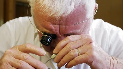 Close-up of horologist repairing a watch