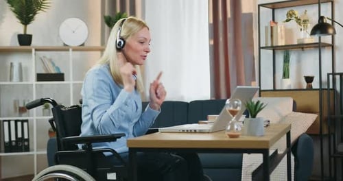 Woman in Wheelchair Engaged in Video Conference
