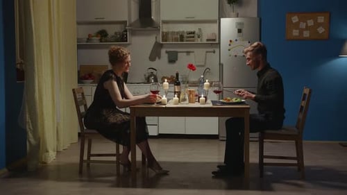 Couple Enjoying Romantic Candlelit Dinner at Home